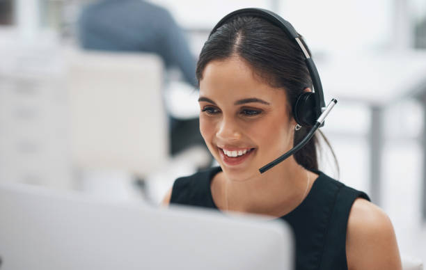 procare call center Happy woman, face and headphones in call center for customer service, telemarketing or support at office. Female person, consultant or agent smile with headset for online advice or help at workplace